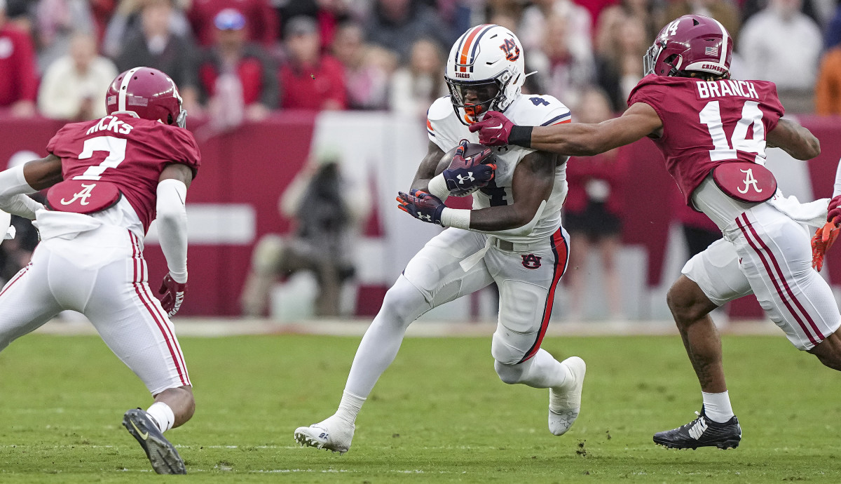 Tank Bigsby (4) tries to break through the tackle during the game between Auburn and Alabama at Bryant-Denny Stadium. Austin Perryman/AU Athletics
